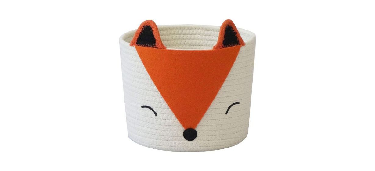 A round woven basket with a design of a fox's face on it and ears sticking out
