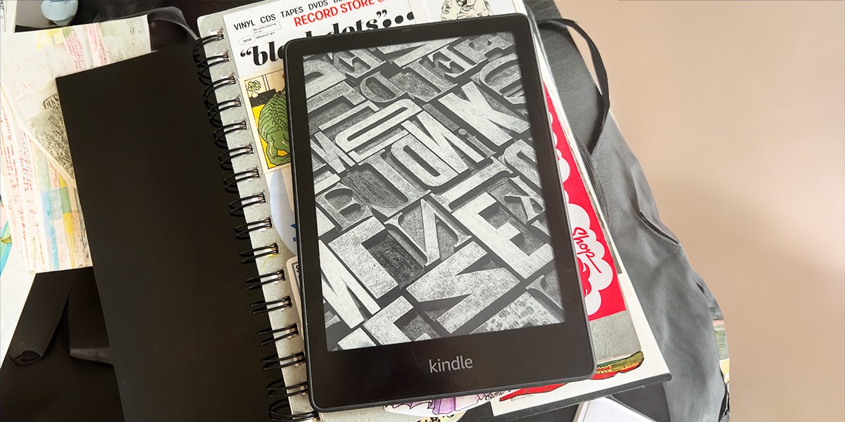 Kindle Paperwhite Signature on stack of books