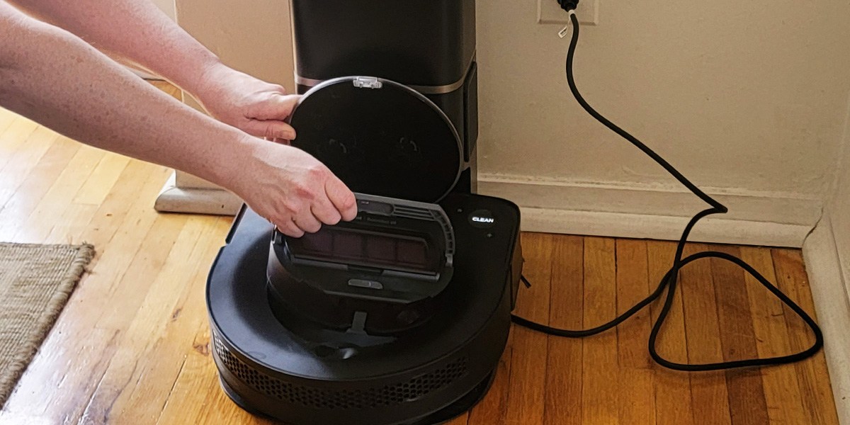 Person checking Roomba's clean base