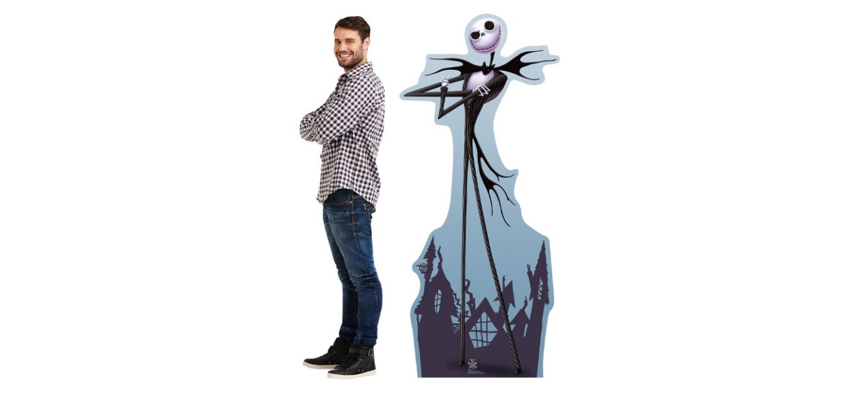 Man standing next to Cardboard People Jack Skellington Life-Size Cutout