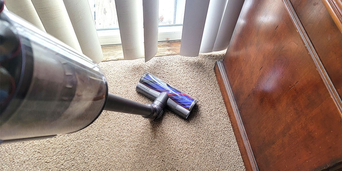 Dyson V11 Extra cleaning beige area rug