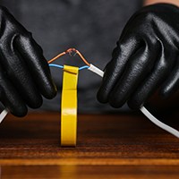 hands using electrical tape